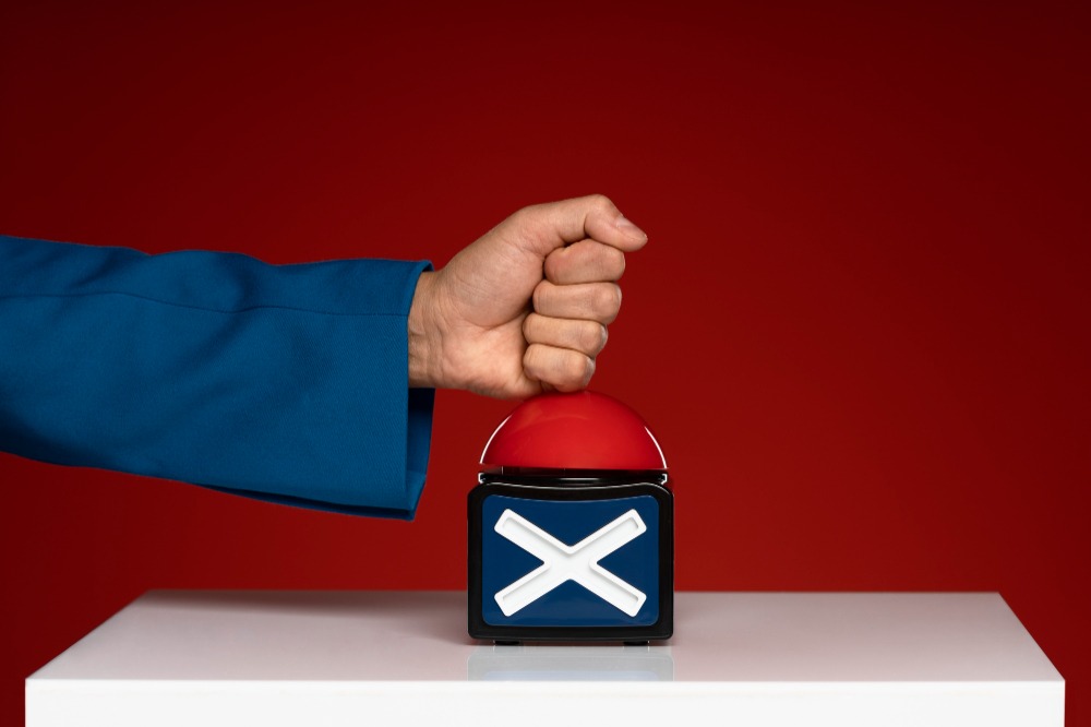 An image of someone pressing a vote button highlighting political risk insurance in south africa
