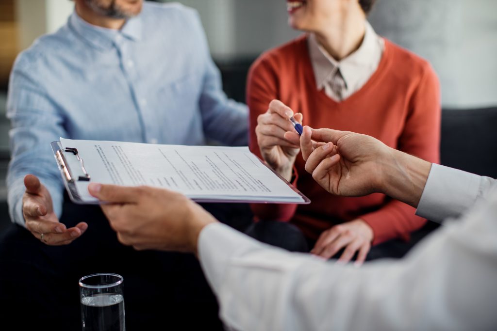 Business partners agreeing to sign up for specialised insurance to protect their business in south africa