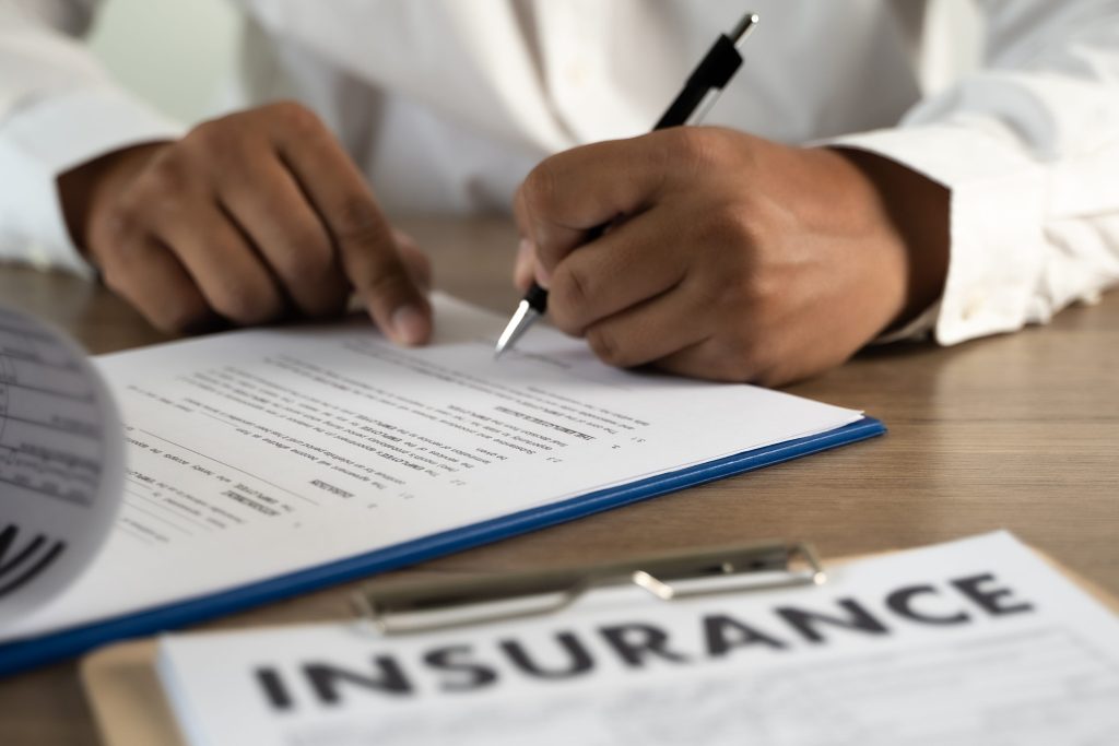 An insurance specialist writing out a policy for specialised insurance in south africa