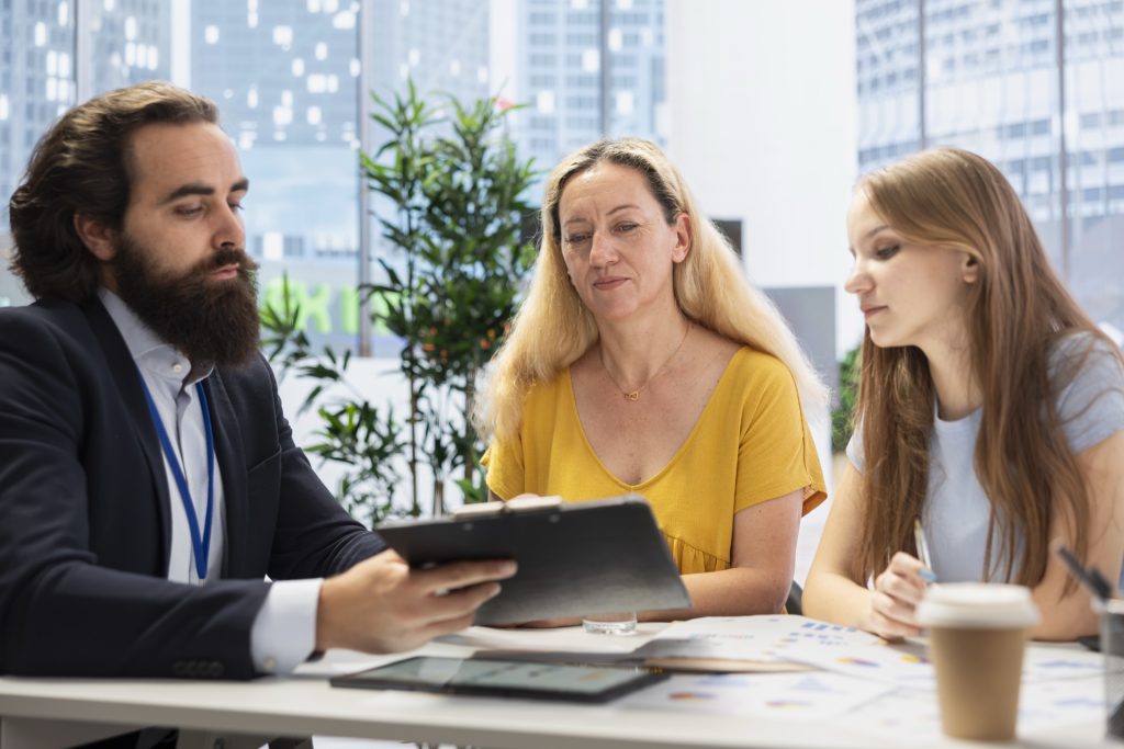 Financial advisor providing consultation to a client in a professional office setting