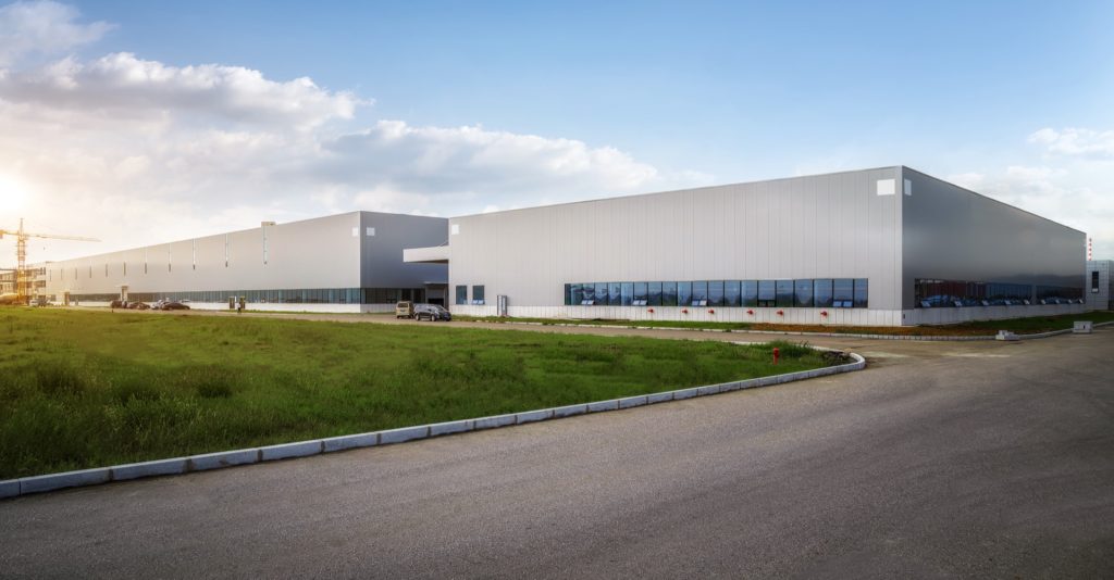 Modern industrial warehouse at sunset — commercial property with business interruption exposure