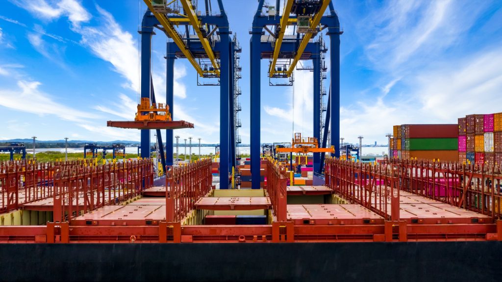 Quay crane loading containers at a south african port terminal: commercial marine logistics