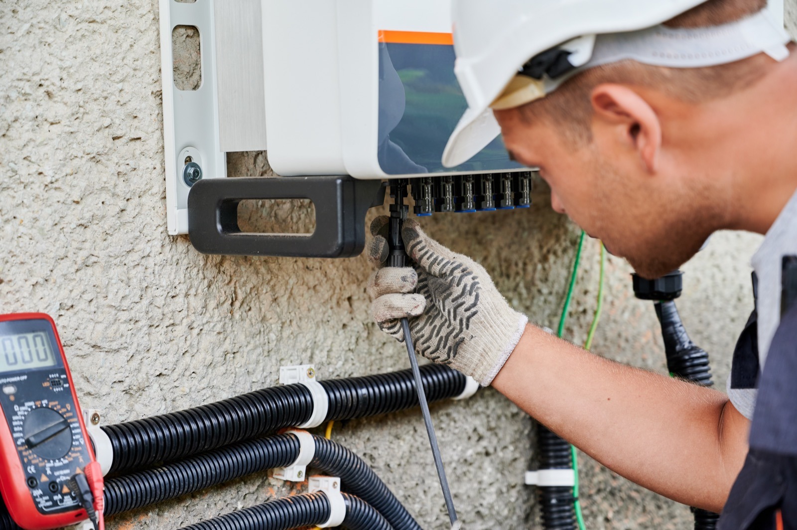 Registered electrical installer wiring a solar inverter and dc electrical box — installer competency and certificate of compliance are core requirements for commercial pv cover