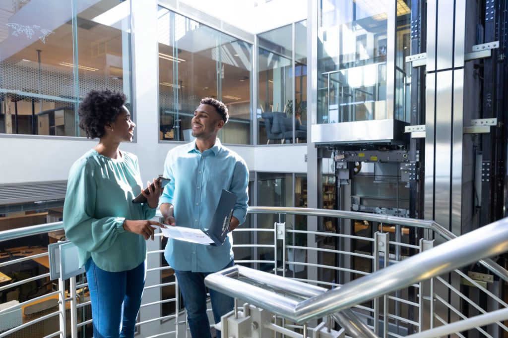 Two african professionals reviewing a business file together. Berkley risk conducts a structured review of public liability cover for every placement