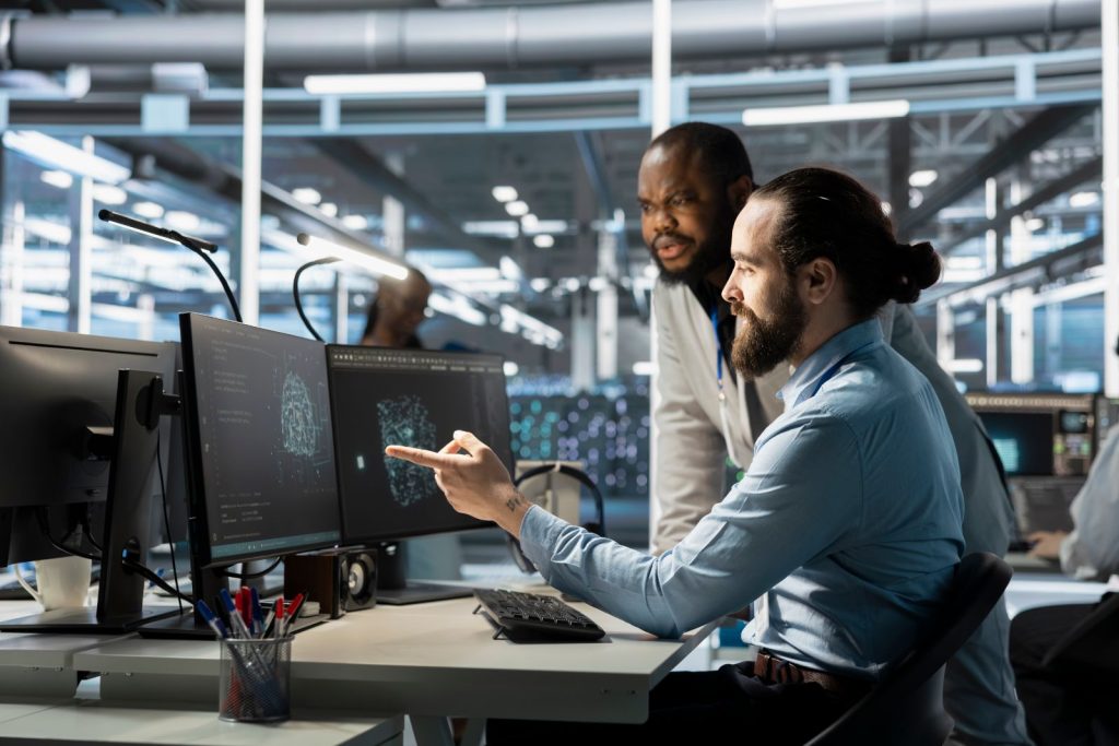 Two engineers reviewing ai model outputs on screen before they reach a client
