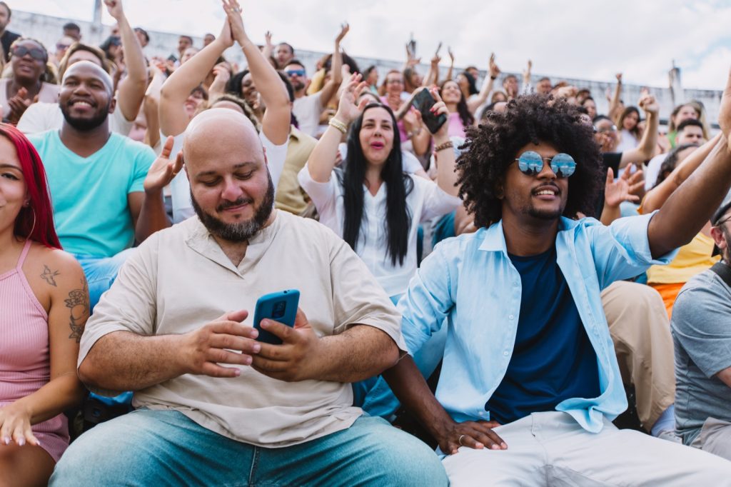Spectators cheering in a packed stadium. Large public events carry crowd-related liability exposures for organisers and venue owners