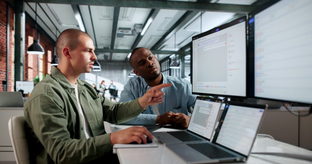 Two it service managers reviewing incident tickets, where service failures can lead to client claims